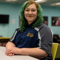 Photo of Dre Duvendack sitting at a table