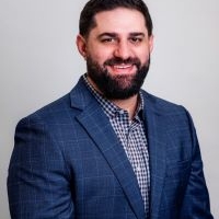 headshot of Adam Unes