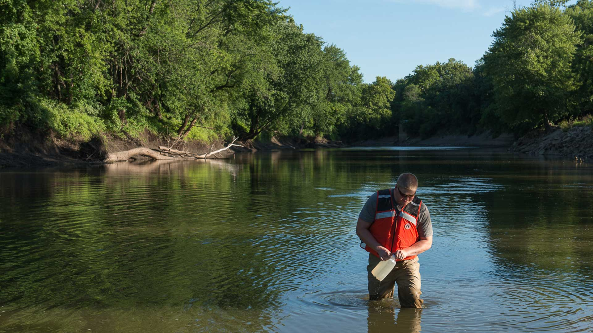 sutdent testing water in river