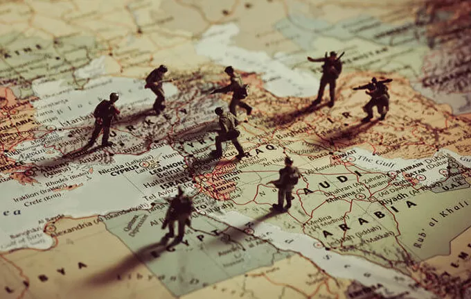 toy solders placed on a map of the Middle East