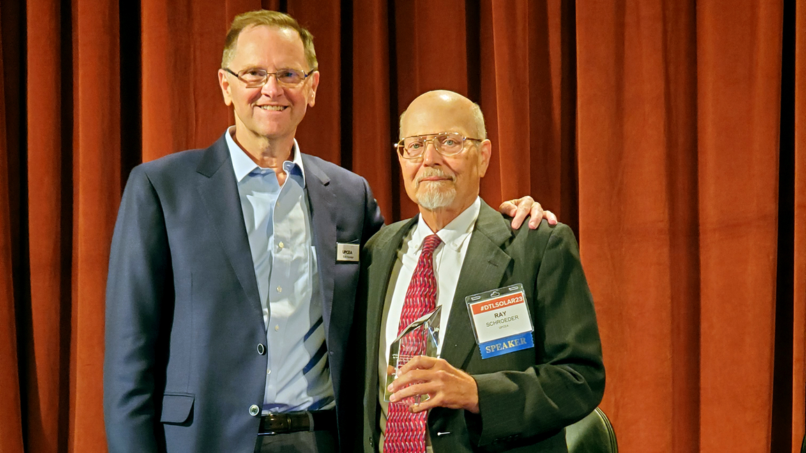 Raymond Schroeder with award