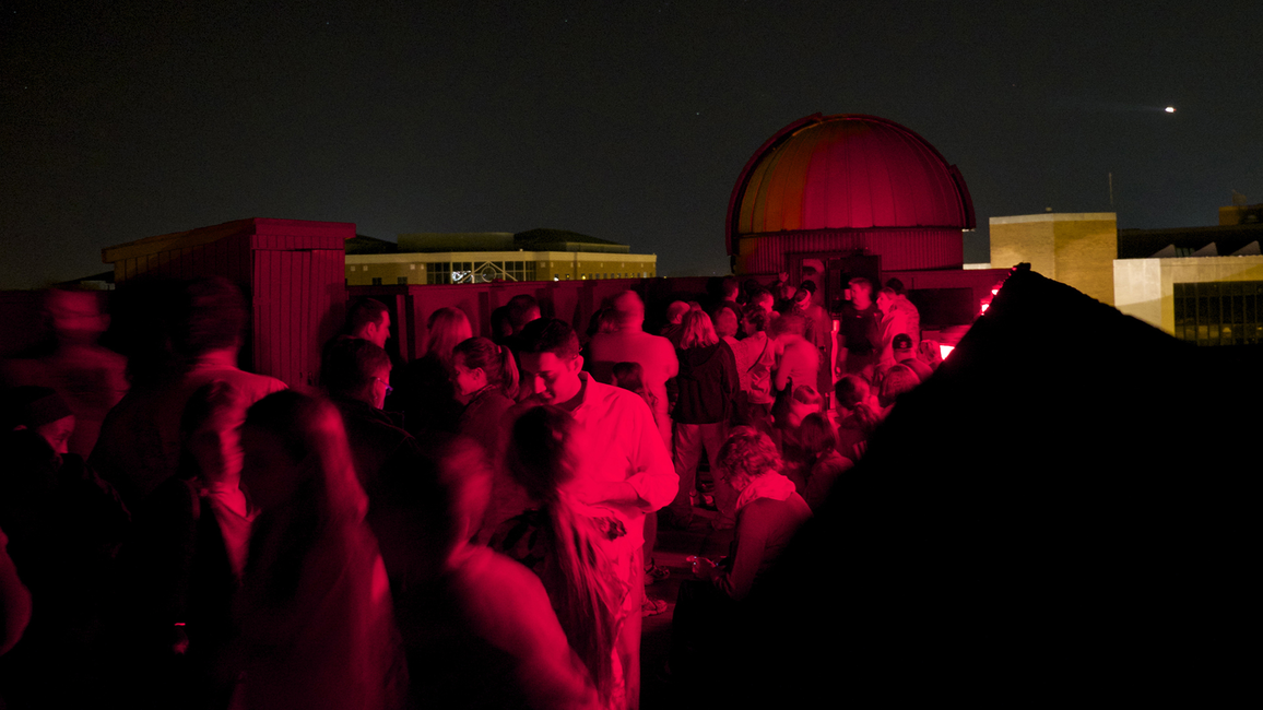 A crowd of people on the roof of Brookens Library for a Star Party.