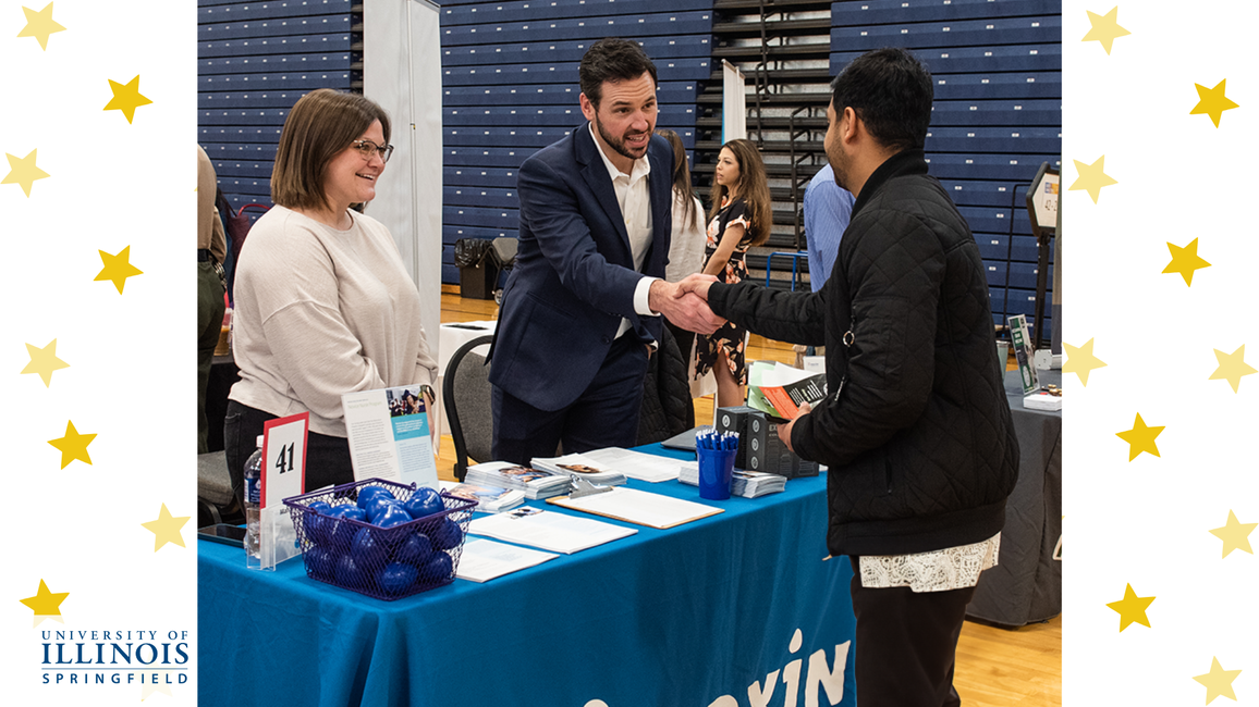An employer meeting a student at a job fair.