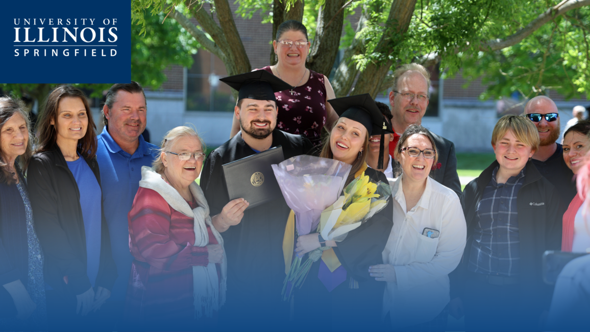 A family taking a picture at graduation.