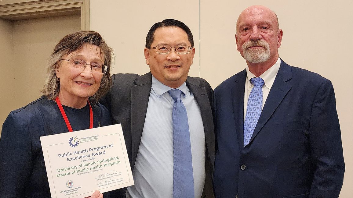 Lenore Killam, Brian Chen and a third person pose with the Illinois Public Health Association Public Health Program award.