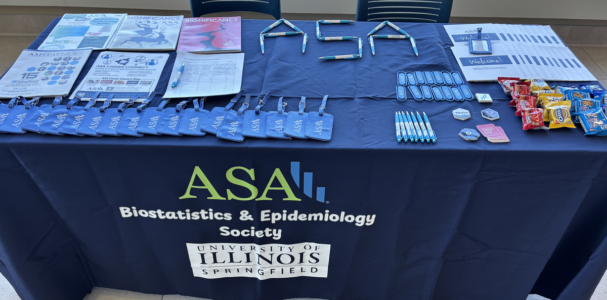 ASA table display with flyers, brochures, and University of Illinois logo.