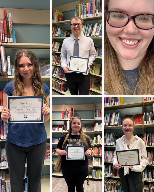 Five people in a library holding certificates, smiling.