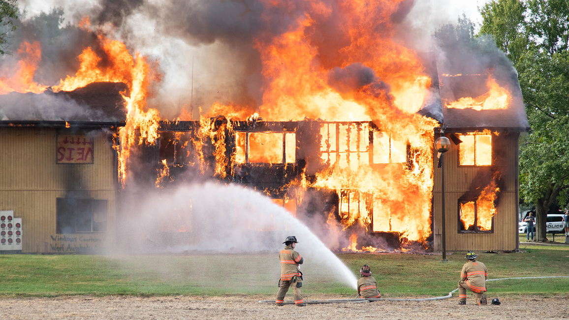 Firefighters extinguishing a massive building fire.
