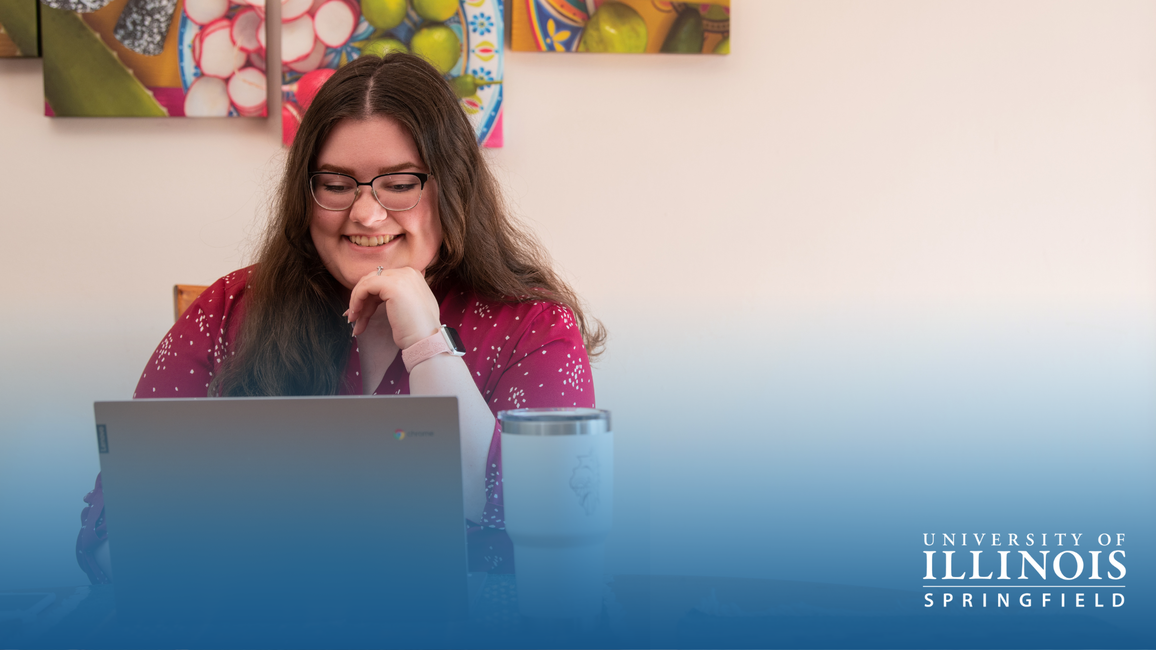Woman smiling at laptop, University of Illinois Springfield logo in corner.