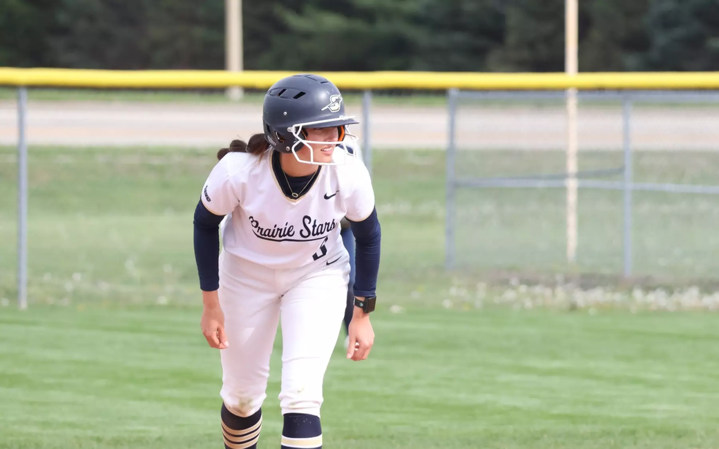 Jaden Watts playing softball in white UIS uniform