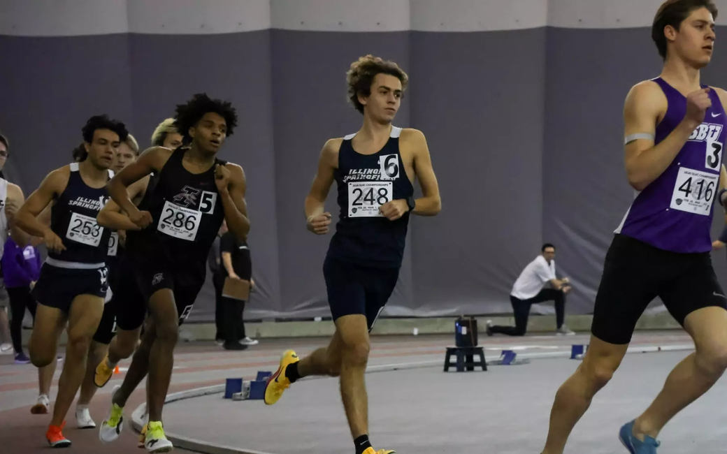 Charlie Borlin running indoor track at GLVC Championships