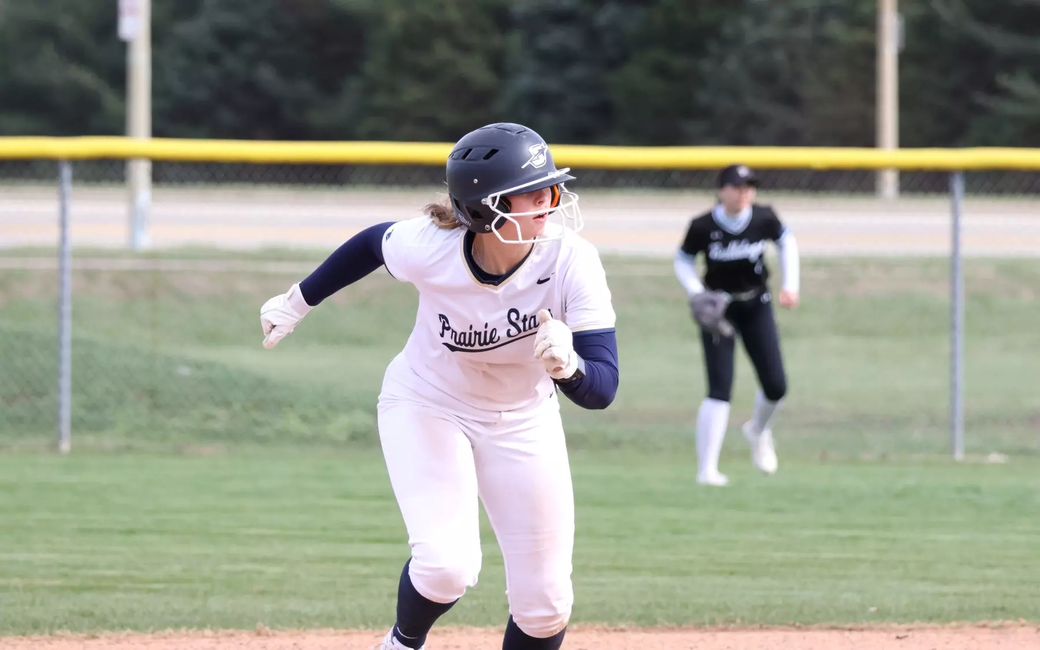 Rachel McMullen running the bases in white UIS softball uniform