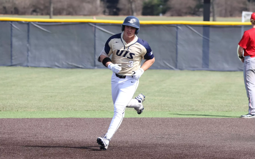 Kaden Griffitts running the bases in gold UIS uniform