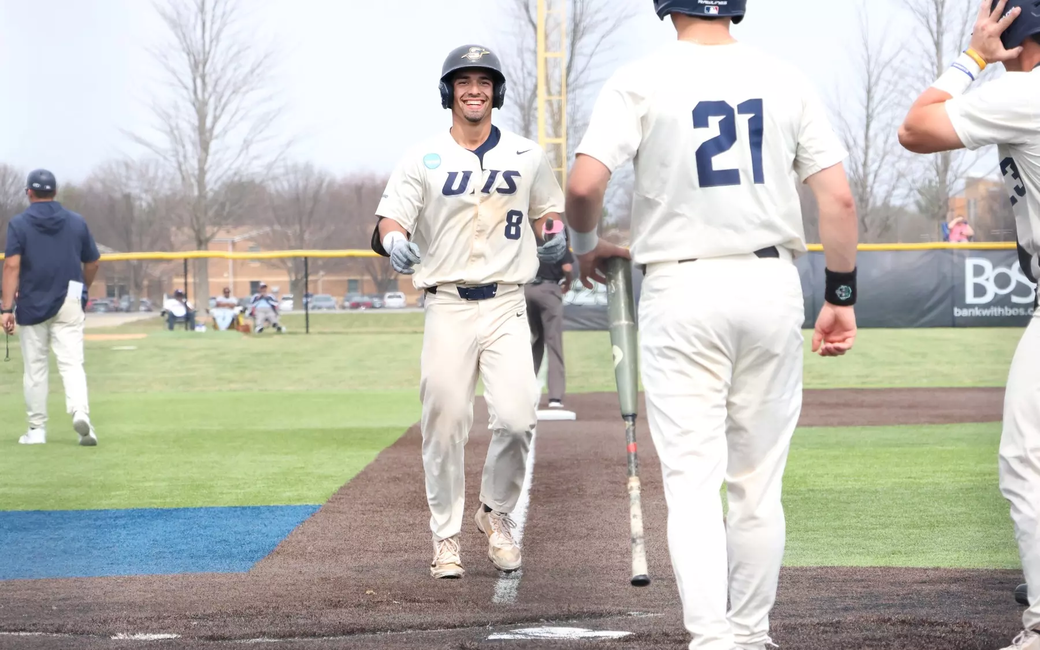 Noah Caceres celebrates hitting a home run in white UIS baseball uniform