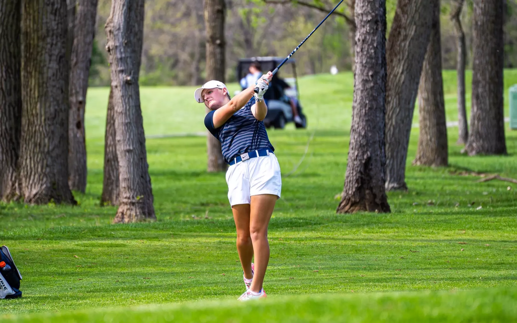 Elaine Grant golfing in UIS blue and white at GLVC Championship