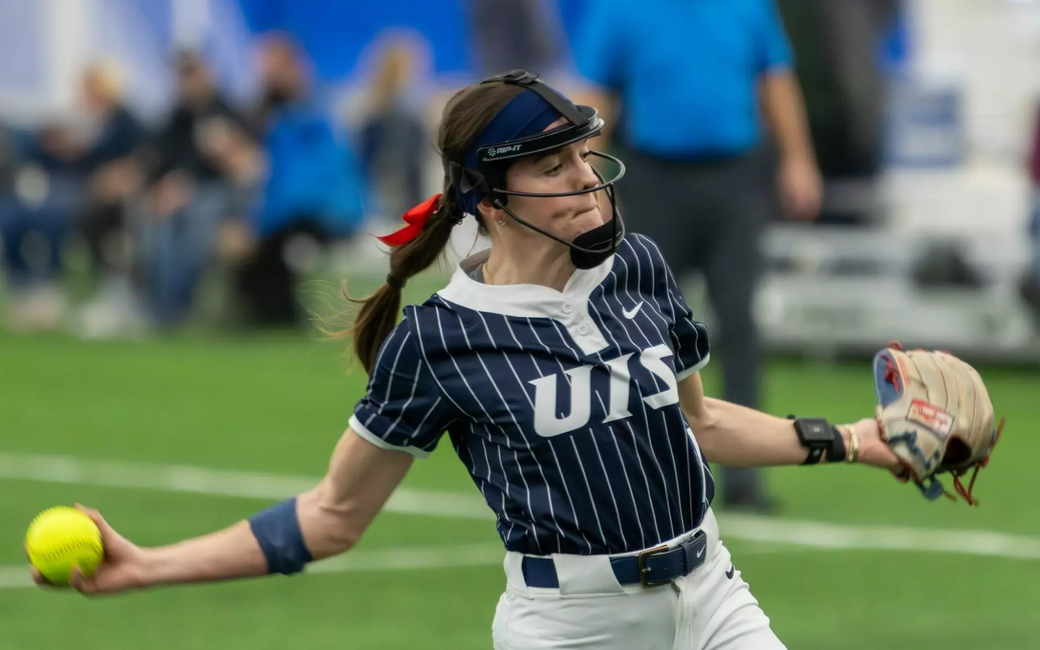 Rosie Bartletti pitching in blue UIS uniform
