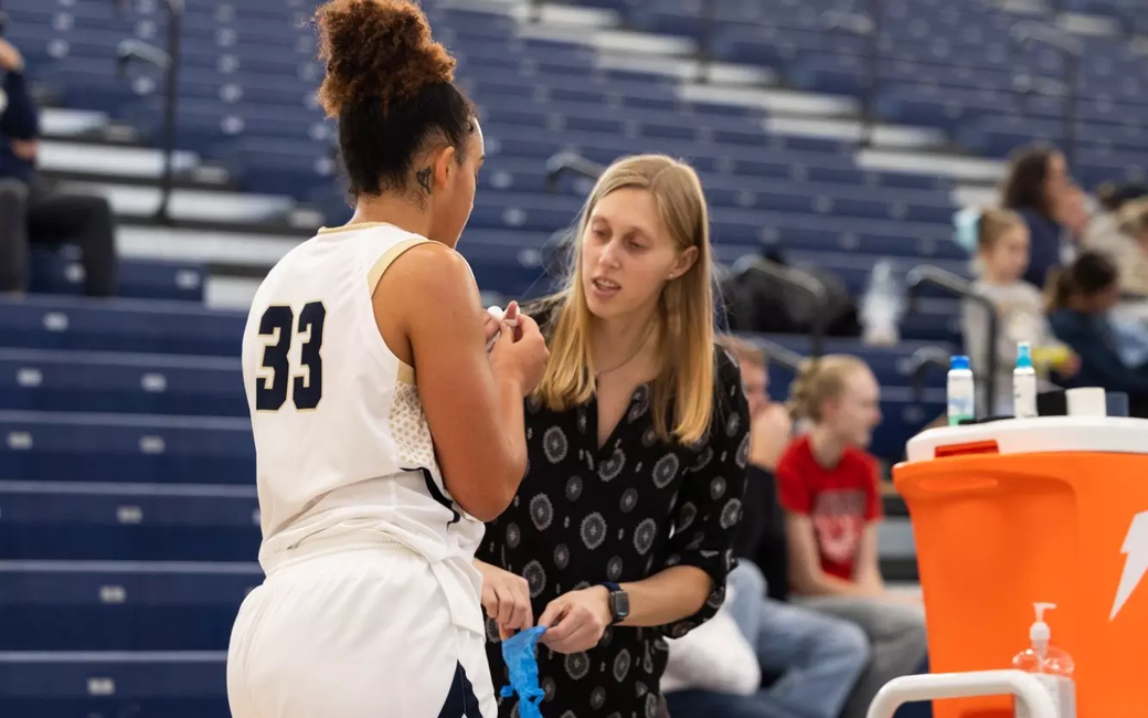 Abby Kain, athletic trainer attending to a student-athlete