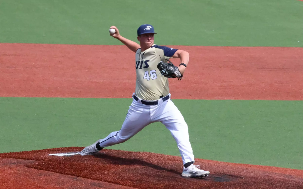 Brayden Mayer pitching for UIS baseball in gold uniform
