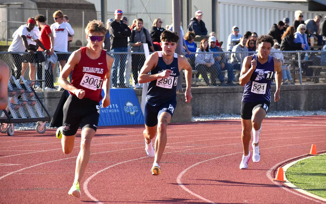 River Derby running outdoor track in blue UIS uniform