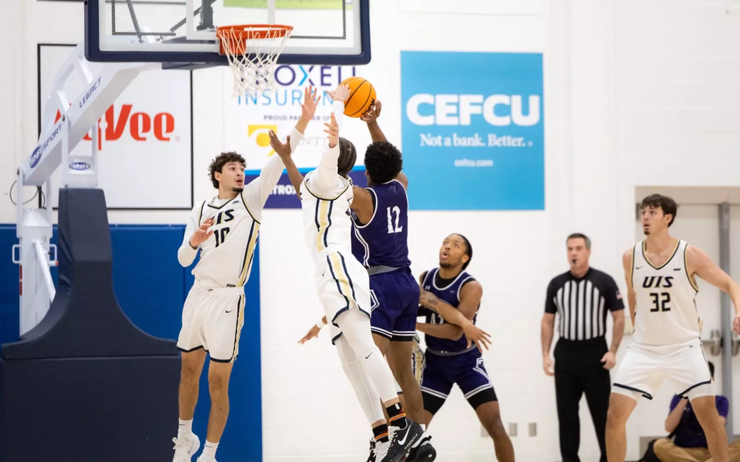 Isaiah Davis goes up for a block in men's basketball
