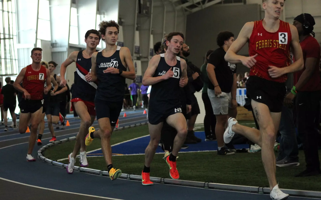 UIS men's track athletes running an indoor race