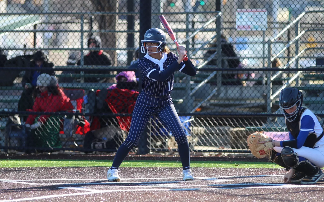 Sidney Sawyer playing softball in blue UIS uniform
