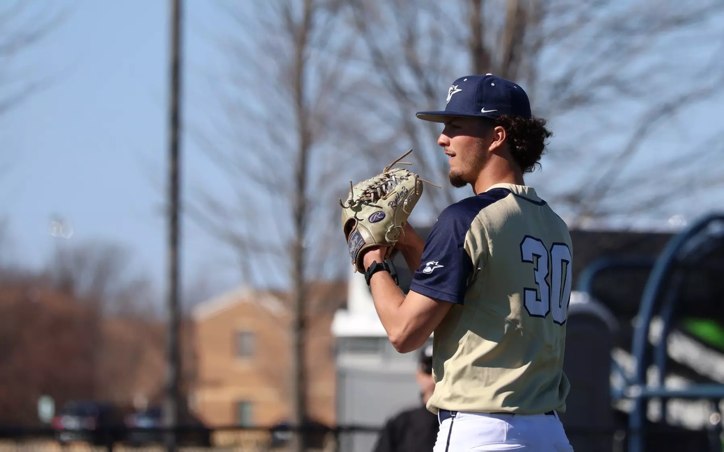Richie Snider pitching in gold UIS uniform