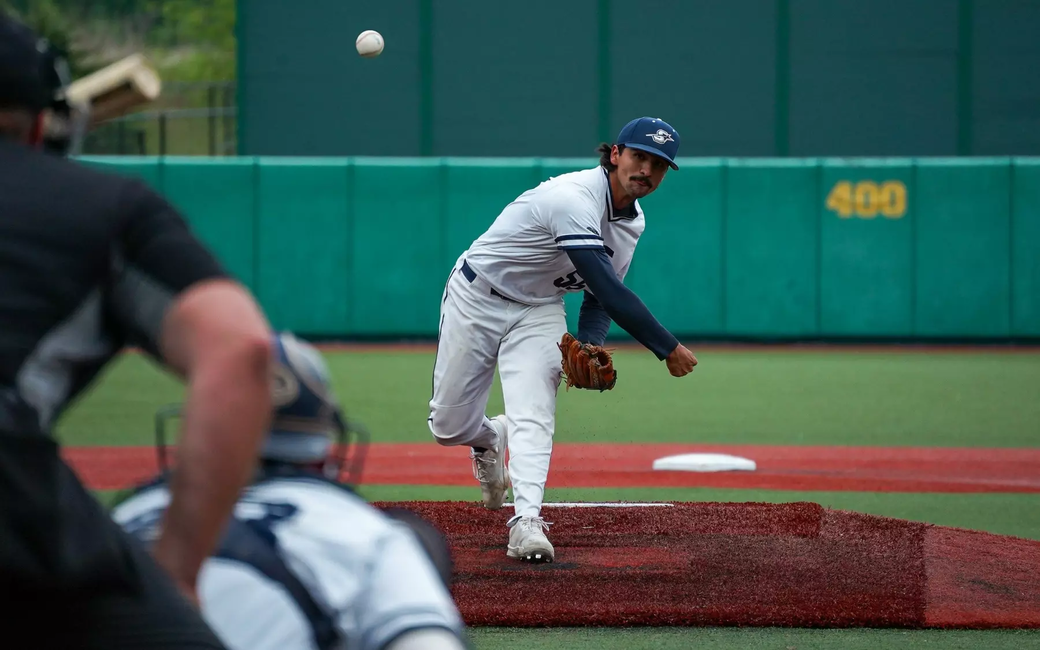 Esteban Hernandez pitching in white UIS uniform
