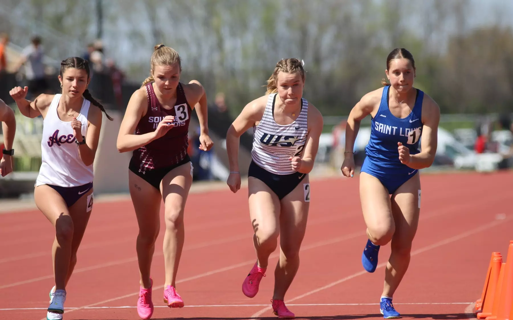Camille Terre racing off starting line in outdoor track