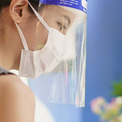 Woman working with mask and face shield