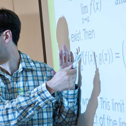 UIS math professor teaching at whiteboard