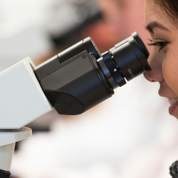student looking through microscope