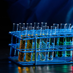 test tubes being filled with colorful liquid
