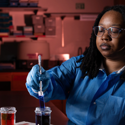student performing microbiology testing