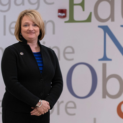 teacher in front of word wall