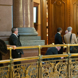 several people at the railing of the second floor of the Illinois Capitol Building