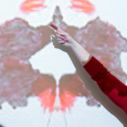 psychology professor pointing to a Rorschach test on an overhead projector