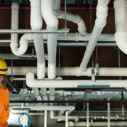 student looking at pipes
