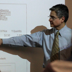 professor teaching in front of whiteboard