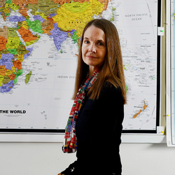 professor in front of map
