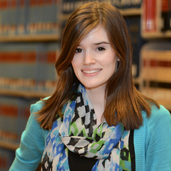 student in front of law books
