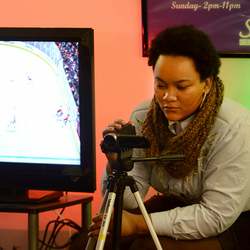 student photographing another student