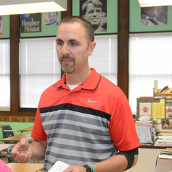 a teacher talking to a middle school student