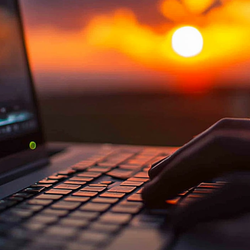 close up of hands on a laptop keyboard editing a video