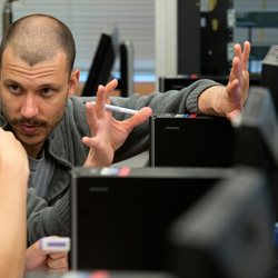 a professor explaining something on a computer to a student