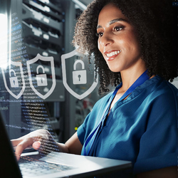 woman at laptop with cybersecurity iconography surrounding her