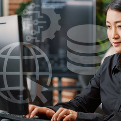 Woman working on a computer in an office setting.
