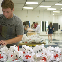a student volunteer making emergency kits for the Red Cross