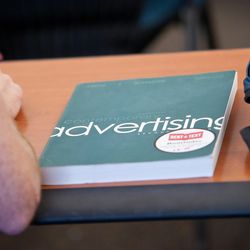 an advertising textbook on a student's desk