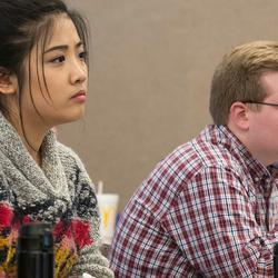 Students in a classroom attentively taking notes.